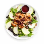 Grilled Chicken Apple Pecan Salad with fresh mixed greens, Granny Smith apples, candied pecans, dried cranberries, feta cheese, and fat-free raspberry vinaigrette