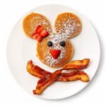 A fun and delicious kids breakfast combo featuring a mouse shaped pancake and crispy bacon at The Eggsquisite Cafe