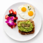 Avocado Toast at Eggsquisite Cafe with multigrain toast, fresh avocado, lemon, olive oil, sea salt, everything bagel seasoning, and eggs.