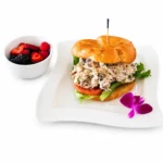Chicken Salad Sandwich at Eggsquisite Cafe with fresh lettuce and tomatoes on your choice of bread or croissant.