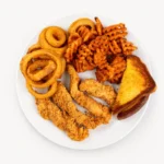 Chicken Tenderloin lunch at Eggsquisite Cafe with tender seasoned chicken and two lunch sides.