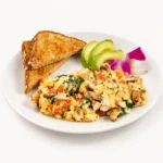 Iron Man Scrambler at Eggsquisite Cafe with egg whites, spinach, tomatoes, onions, mushrooms, avocado, and toast.