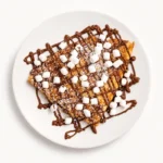 S'mores Crepe at Eggsquisite Cafe filled with Nutella, marshmallows, and graham crackers for a sweet breakfast or brunch treat.