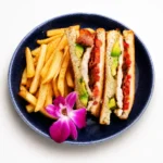 Ranch Chicken Melt at Eggsquisite Cafe with grilled chicken, bacon, tomatoes, Swiss cheese, avocado, and buttermilk ranch on sourdough.