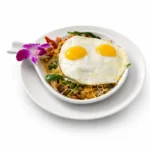 Veggie Skillet at Eggsquisite Cafe with roasted tomatoes, mushrooms, onions, spinach, green peppers, cheese, hash browns, and two eggs.