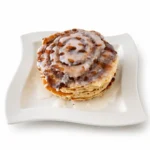 Cinnamon Roll Pancakes at Eggsquisite Cafe with cinnamon butter swirl, vanilla glaze, and a soft fluffy pancake texture.