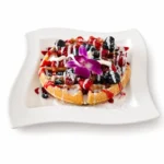 Gluten-Friendly breakfast at Eggsquisite Cafe with French toast, waffles, or pancakes served with powdered sugar.