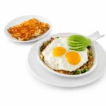 Santa Fe Skillet at Eggsquisite Cafe with chorizo, jalapeños, onions, tomatoes, Monterey Jack and cheddar cheese, avocado, hash browns, and two eggs.