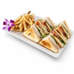 Turkey Club sandwich at Eggsquisite Cafe with sliced turkey, bacon, lettuce, tomatoes, and mayo on toasted white bread.