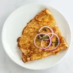 Smoked Salmon Crepe at Eggsquisite Cafe with smoked salmon, avocado, red onions, capers, and cream cheese, served with a breakfast side.